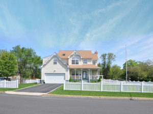 modern victorian style home with white picket fence