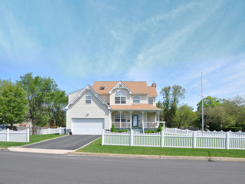 modern victorian style home with white picket fence