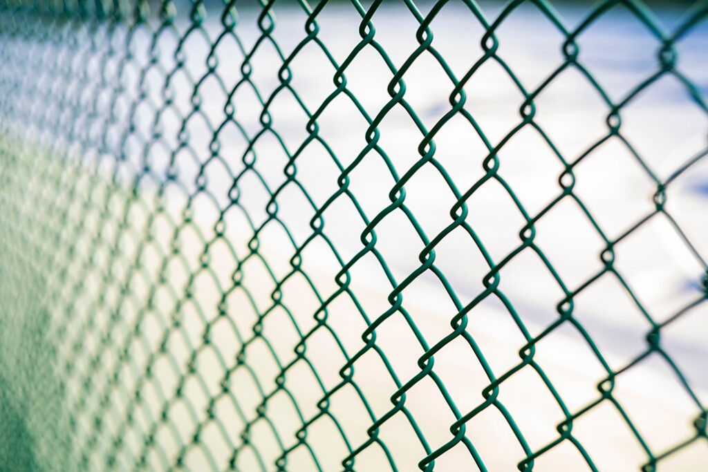 Close-up chain link fence , Sunset background
