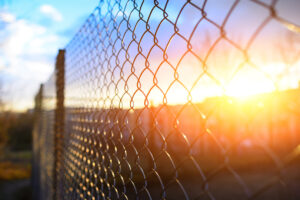 Chain link fence at sunset