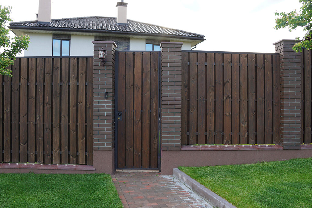 brown wooden plank fence and a closed door outside